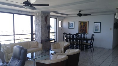 Another View Of Living Room and Dining Room With Ceiling Fans. 