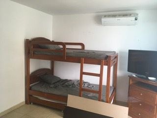   Suite Bedroom With Split Air Conditioner And Television. 