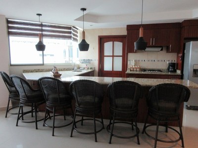   Kitchen View With Huge Bar Area. 