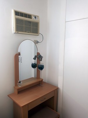 VanityTable And Air Conditioner In Bedroom