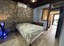 Stone Wall Is Feature Of Master Bedroom