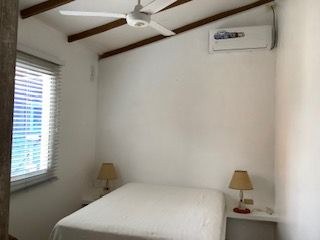   First Bedroom With Ceiling Fan And Air Conditioner 