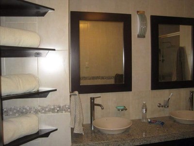   Double Sinks And Glass Shelving In Master Bathroom. 