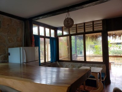 Kitchen View To Living Area And Covered Patio
