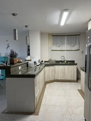 Granite Countertops And Breakfast Bar In Kitchen.