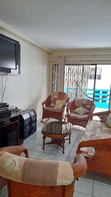 View Of Living Area And Sliding Glass Door Access To Balcony