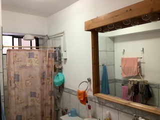 Shower And Wood-Framed Vanity Mirror