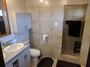 Full bath with walk in shower and double sink.