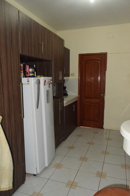 Refrigerator And Cabinets In Kitchen