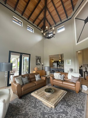 central living room with the vaulted ceilings, electric fireplace